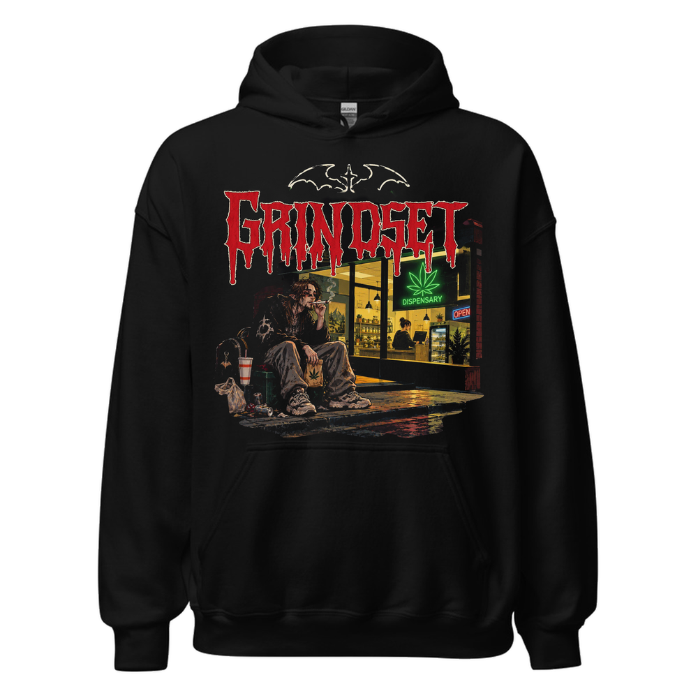 Black hoodie with a large illustration on the chest of a long-haired man sitting on a milk crate outside a lit dispensary at night, red dripping lettering above